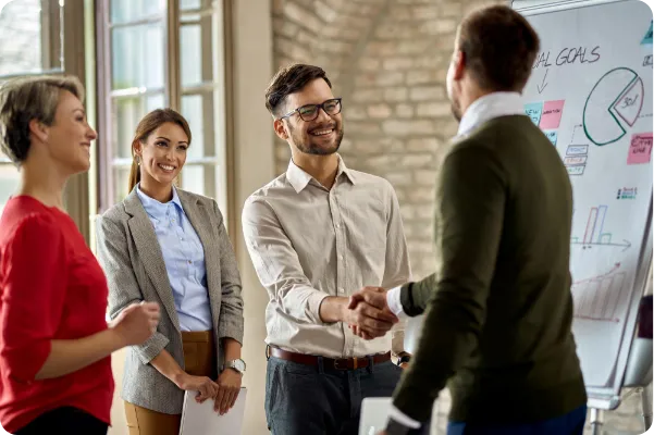 happy-coworkes-shaking-hands-after-business-presentation-office