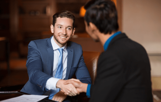 two-happy-partners-shaking-hands-cafe